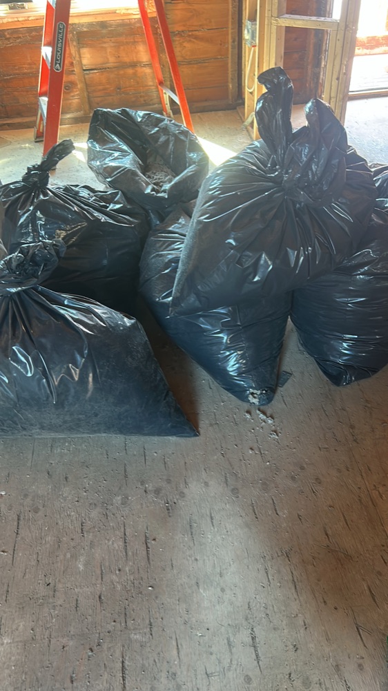 Bagged debris cleared from the job site